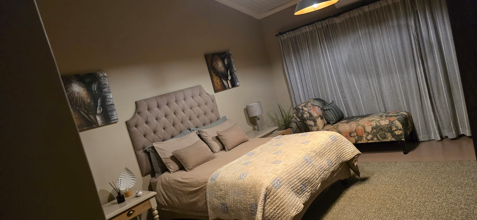 Warm, spacious bedroom with upholstered headboard