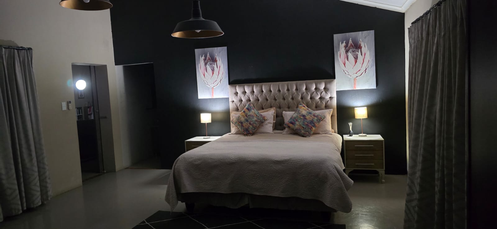 Inari bedroom with a dark feature wall and bedside lamps